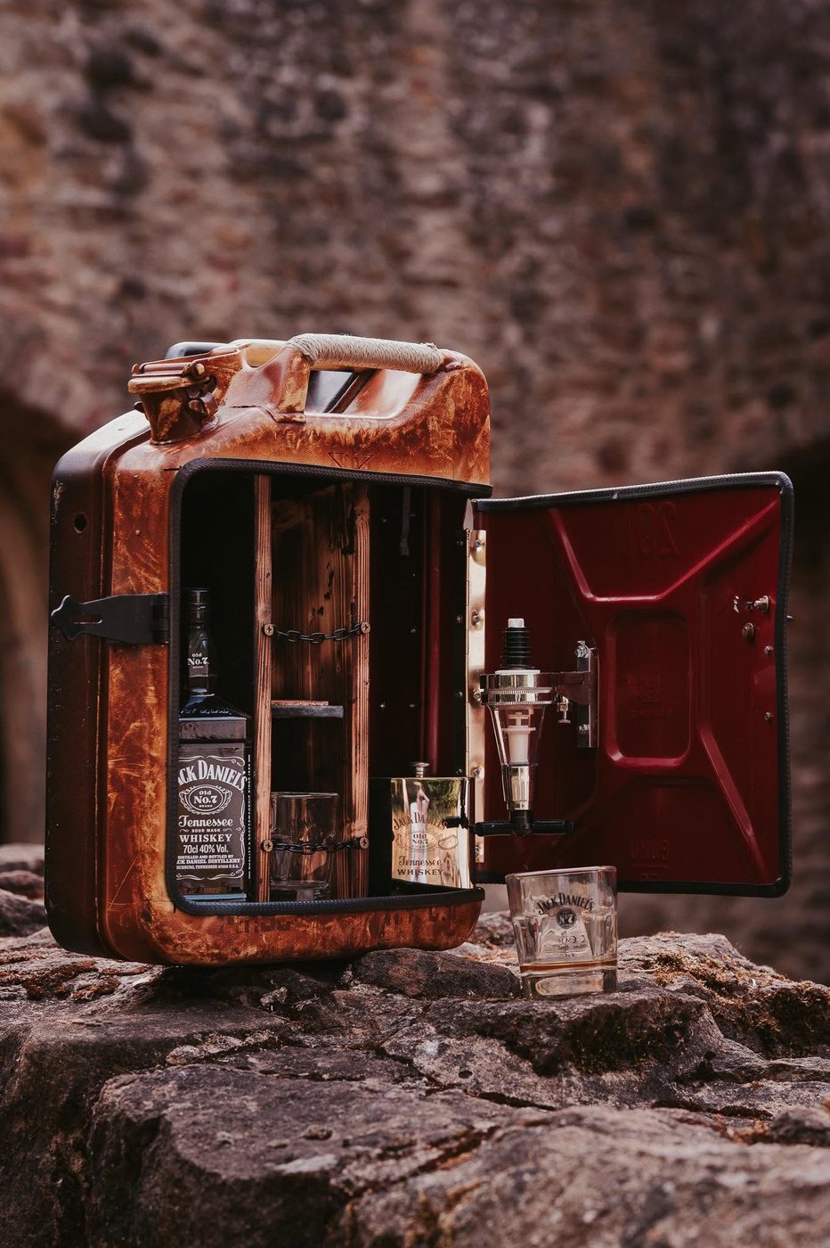 Ge&ouml;ffneter Spiritkanister mit Whiskyflasche, Gl&auml;sern und Zapfhahn